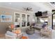 Covered patio with ceiling fan, seating area, TV, and views of the pool at 3325 W Wallcraft Ave, Tampa, FL 33611