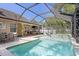 A beautiful pool area features a spa, patio seating, and lush landscaping at 3325 W Wallcraft Ave, Tampa, FL 33611