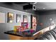 Wet bar with a black countertop, snacks, and movie-themed decor in a home theater setting at 3325 W Wallcraft Ave, Tampa, FL 33611