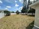 Large backyard surrounded by a white fence and mature trees at 3599 66Th N Way, St Petersburg, FL 33710