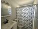 Cozy bathroom with shower featuring white tile, vanity, and sink at 3599 66Th N Way, St Petersburg, FL 33710