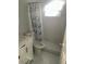 Bathroom featuring white tile and blue floral shower curtain at 3599 66Th N Way, St Petersburg, FL 33710