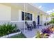 Inviting front porch with charming seating and well-maintained landscaping at 3599 66Th N Way, St Petersburg, FL 33710
