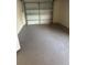 Spacious garage with large garage door, painted floors and ample room for storage at 3599 66Th N Way, St Petersburg, FL 33710