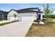 Attractive home featuring a two-car garage, well-maintained lawn, and tasteful exterior design at 3717 Nandina Cir, Sun City Center, FL 33573
