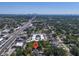 Aerial view of a home in a lush neighborhood with the city skyline in the distance at 4251 W Roland St, Tampa, FL 33609