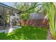 The backyard features lush artificial turf, a modern screened porch, and a privacy fence at 4251 W Roland St, Tampa, FL 33609