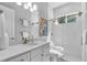 Modern bathroom with white subway tile, glass shower, and quartz countertop vanity at 4251 W Roland St, Tampa, FL 33609