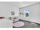 Charming Bedroom with white walls, a crib, and a window letting in natural light at 4251 W Roland St, Tampa, FL 33609