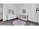 Bright Bedroom featuring gray carpet, crib, dresser, and round pink rug at 4251 W Roland St, Tampa, FL 33609
