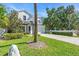 Well-maintained home with a manicured lawn, brick driveway, and ample greenery at 4251 W Roland St, Tampa, FL 33609