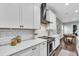 Kitchen features white cabinets, quartz countertops, stainless steel appliances and hardwood floors at 4251 W Roland St, Tampa, FL 33609