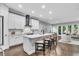 Modern white kitchen with a large island, stainless steel appliances, and hardwood floors at 4251 W Roland St, Tampa, FL 33609
