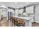 Modern white kitchen features a large island with bar seating and stainless steel appliances at 4251 W Roland St, Tampa, FL 33609