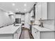Bright kitchen with white cabinetry, stainless steel appliances, and quartz countertops at 4251 W Roland St, Tampa, FL 33609