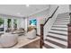 Cozy living room with staircase, hardwood floors, and a large flat screen television at 4251 W Roland St, Tampa, FL 33609