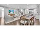 Open concept living space featuring hardwood floors, living and dining area and open kitchen at 4251 W Roland St, Tampa, FL 33609
