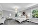 Serene main bedroom with neutral tones, carpet, and ample natural light from surrounding windows at 4251 W Roland St, Tampa, FL 33609