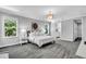 Calm and inviting main bedroom with carpet, natural light, and ensuite bathroom access at 4251 W Roland St, Tampa, FL 33609