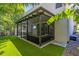 Relax in this screened porch with a ceiling fan and comfortable furniture at 4251 W Roland St, Tampa, FL 33609