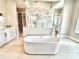 Bright bathroom featuring a soaking tub, a glass shower, and double vanities at 4321 S Renellie Dr, Tampa, FL 33611