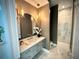 Stylish bathroom boasts elegant lighting, a round mirror, and marble flooring at 4321 S Renellie Dr, Tampa, FL 33611