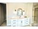 Bright bathroom features an oval mirror, marble countertop, and custom fixtures at 4321 S Renellie Dr, Tampa, FL 33611