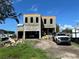 New construction home featuring block construction and a two-car garage in a residential neighborhood at 4321 S Renellie Dr, Tampa, FL 33611
