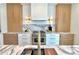 Well-equipped kitchen with marble countertops, stainless steel range, and custom cabinetry for a contemporary design at 4321 S Renellie Dr, Tampa, FL 33611