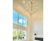 Bright living room with large windows, modern fireplace, and stylish chandelier, perfect for relaxation at 4321 S Renellie Dr, Tampa, FL 33611