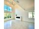 Bright living room with large windows, modern fireplace, and stylish chandelier, perfect for relaxation at 4321 S Renellie Dr, Tampa, FL 33611
