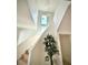 Contemporary staircase with light wood steps and modern lighting fixture, complemented by an interior plant at 4321 S Renellie Dr, Tampa, FL 33611