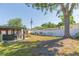 Spacious backyard with white privacy fence, shed, covered patio, and mature trees at 4516 S Trask St, Tampa, FL 33611