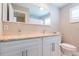 Bathroom with double sinks, granite countertops and white shaker cabinets at 4516 S Trask St, Tampa, FL 33611