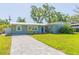 Charming single-story home with a well-manicured lawn and inviting blue front door at 4516 S Trask St, Tampa, FL 33611