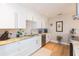 Bright kitchen featuring white cabinets, stone backsplash, stainless steel appliances, and granite countertops at 4516 S Trask St, Tampa, FL 33611