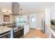 Spacious kitchen showcasing an island with seating, stainless appliances, and modern lighting fixtures at 4516 S Trask St, Tampa, FL 33611