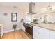 Updated kitchen with stainless appliances, granite counters, modern range hood, and breakfast bar seating at 4516 S Trask St, Tampa, FL 33611