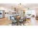 Open floor plan integrating kitchen, dining, and living area with light wood floors and modern decor at 4516 S Trask St, Tampa, FL 33611