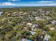 Expansive aerial view of the property showcasing lush greenery and neighborhood with waterfront views and a glimpse of a bridge at 4926 Camellia S Way, St Petersburg, FL 33705