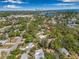 Aerial view of home with a new roof, mature trees, and an in-ground pool in backyard at 4926 Camellia S Way, St Petersburg, FL 33705