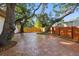 The backyard boasts brick pavers, a wood fence, and lush, mature trees at 4926 Camellia S Way, St Petersburg, FL 33705