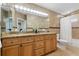 Bathroom featuring a double sink, granite countertops, and a shower/tub combo with neutral colored tile at 4926 Camellia S Way, St Petersburg, FL 33705