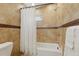 Shower/tub combo featuring neutral colored tile, a shower curtain, and updated fixtures in bathroom at 4926 Camellia S Way, St Petersburg, FL 33705