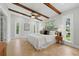 Spacious bedroom featuring a bed, wooden beams on the ceiling, and several windows for natural light at 4926 Camellia S Way, St Petersburg, FL 33705