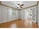 View of a bedroom featuring wood floors, neutral paint, natural light, and a view to the main bedroom at 4926 Camellia S Way, St Petersburg, FL 33705