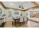 Open dining room with a modern chandelier, neutral colors, and a comfortable dining set at 4926 Camellia S Way, St Petersburg, FL 33705