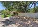 Home exterior with a driveway, large shade trees, lush green lawn and landscaping at 4926 Camellia S Way, St Petersburg, FL 33705