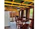 Enclosed patio with rustic wood features, a ceiling fan, outdoor curtains and a dining table that creates a unique space at 5151 22Nd N Ave, St Petersburg, FL 33710