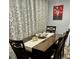 Elegant dining room with dark wooden table and chairs, a stylish table runner, and eye-catching artwork at 5151 22Nd N Ave, St Petersburg, FL 33710